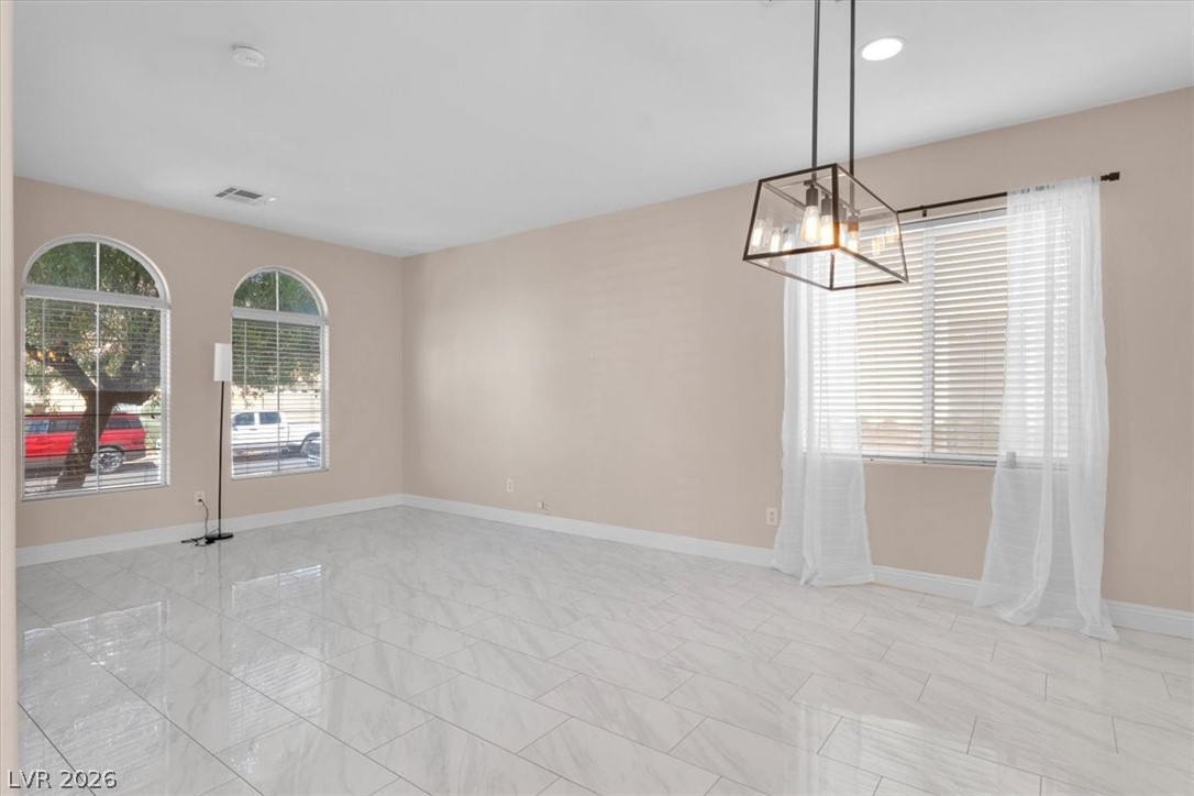 1019 Garnet Ridge Court Las Vegas, NV 89123 - Photo 33 of 34 Unfurnished room with baseboards and hanging lights