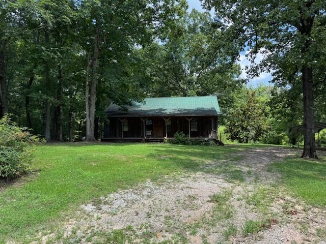 View of front of home featuring a porch and a front lawn