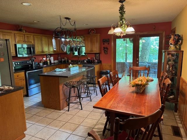 165 Pittman Road Somerville, TN 38068 - Photo 5 of 17 Dining space featuring a textured ceiling, light tile patterned floors, recessed lighting, and a chandelier