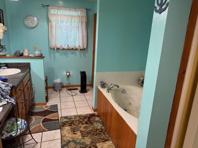 165 Pittman Road Somerville, TN 38068 - Photo 7 of 17 Full bathroom featuring a jetted tub, vanity, and tile patterned floors