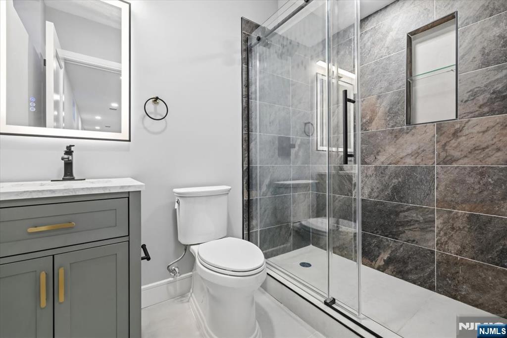 150 Howland Avenue River Edge, NJ 07661 - Photo 39 of 45 a bathroom with a shower a toilet and a sink