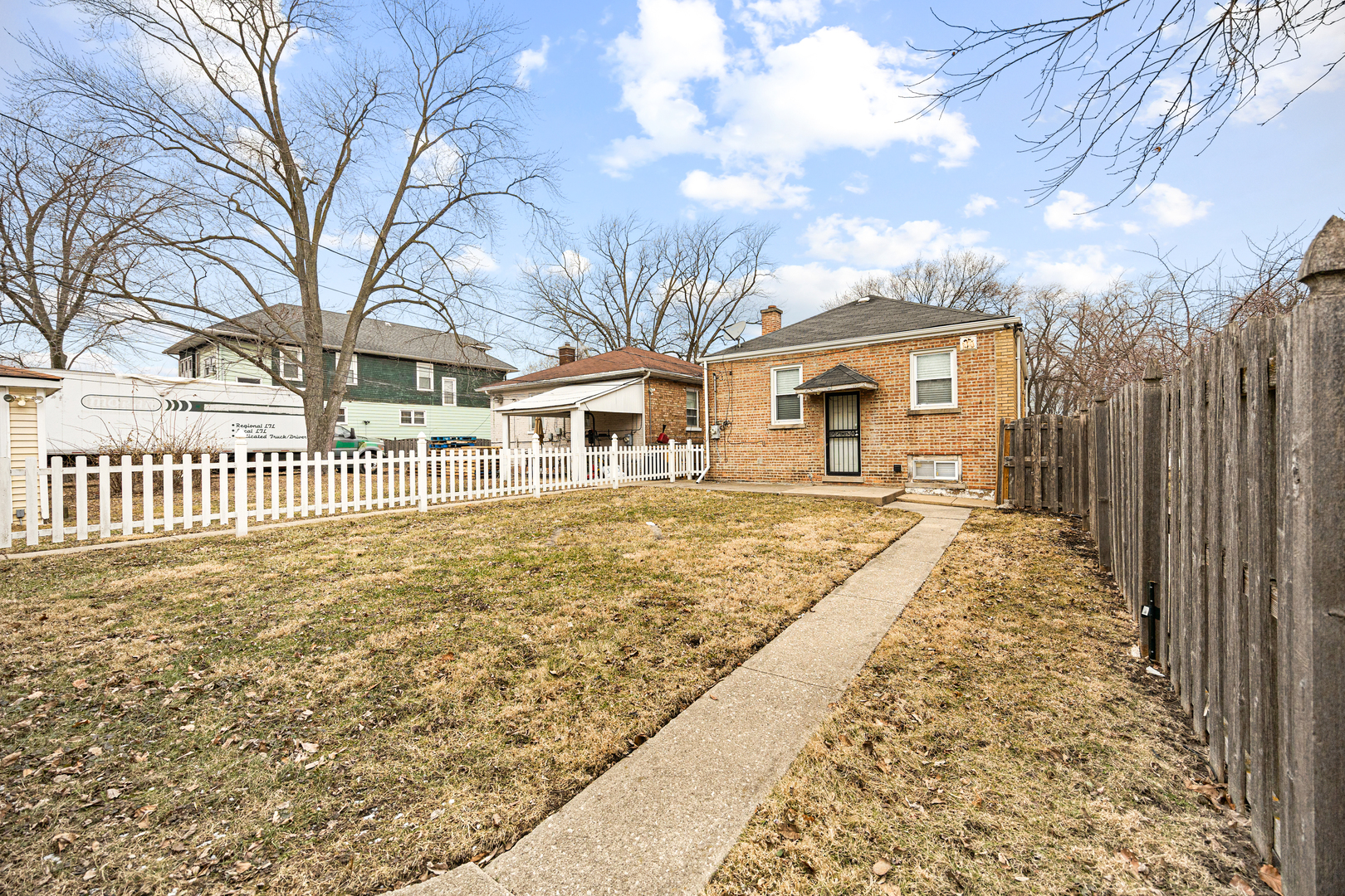 101 West 113th Place Chicago, IL 60628 - Photo 14 of 15 a front view of a house with a yard