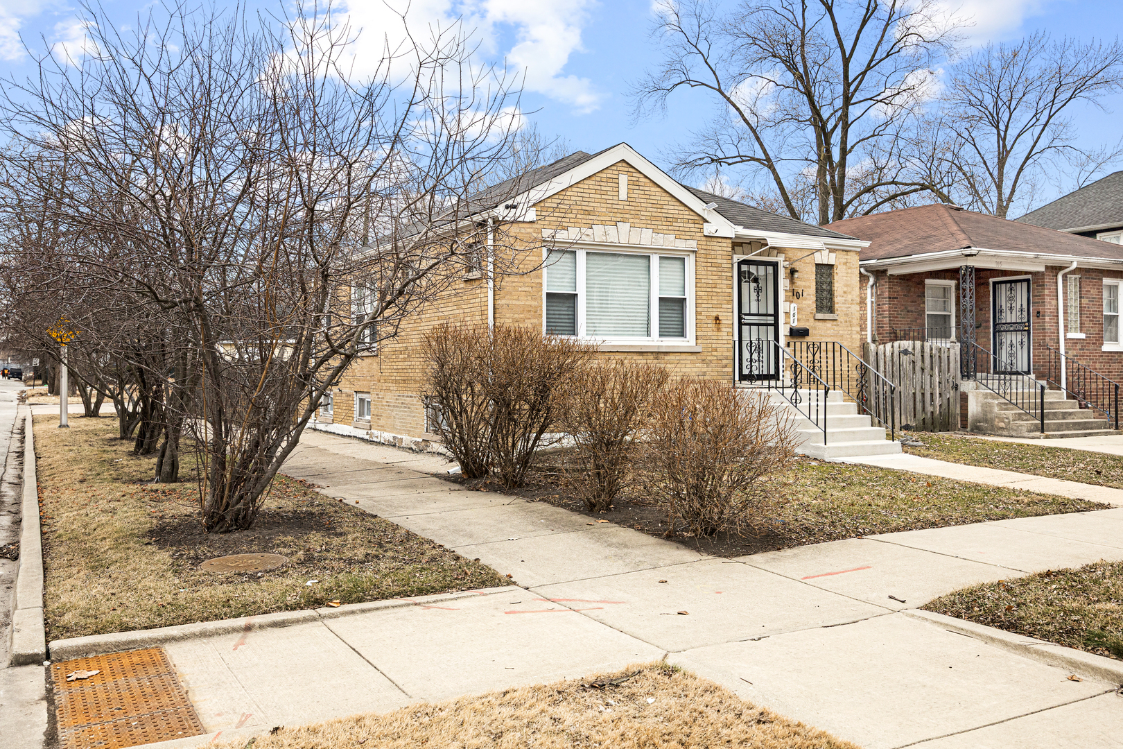 101 West 113th Place Chicago, IL 60628 - Photo 2 of 15 a front view of a house with a yard