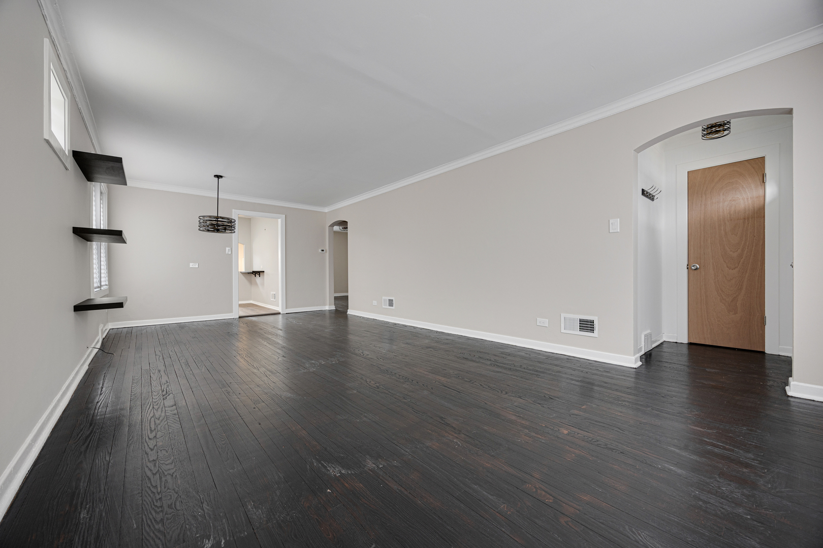 101 West 113th Place Chicago, IL 60628 - Photo 4 of 15 an empty room with wooden floor and windows