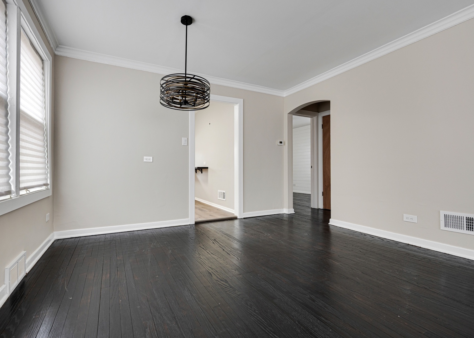 101 West 113th Place Chicago, IL 60628 - Photo 5 of 15 a view of an empty room with wooden floor and a window