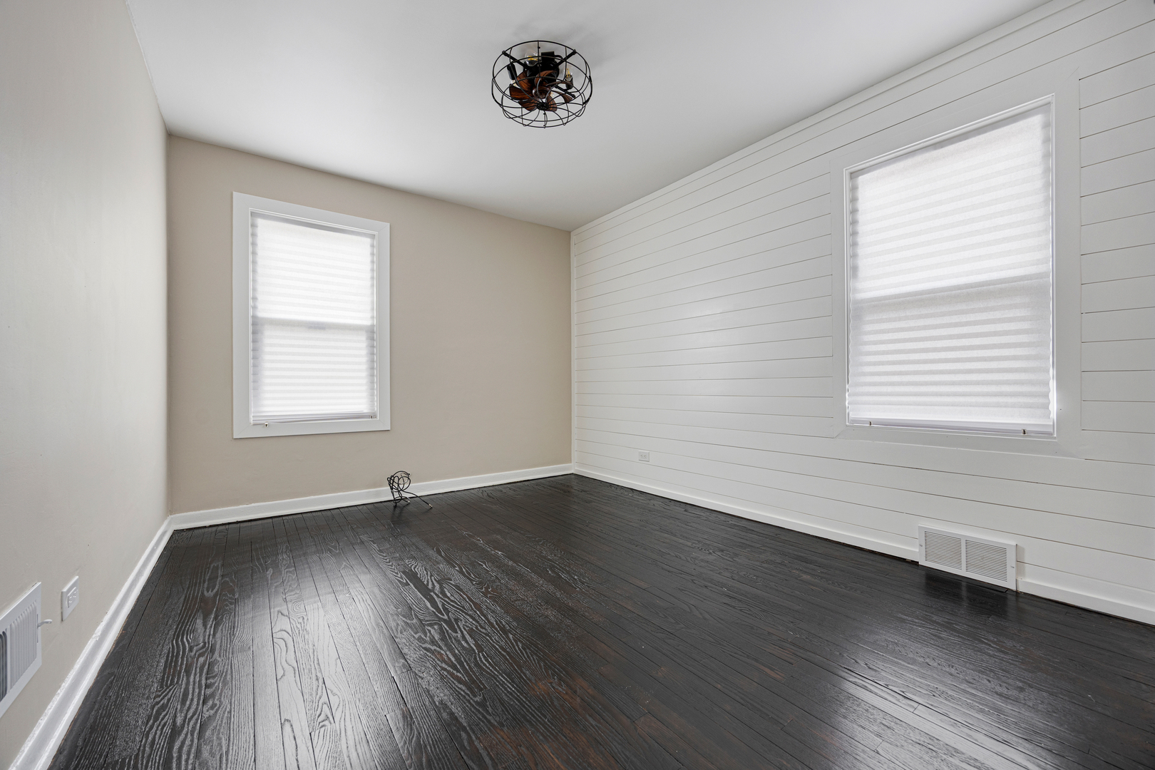101 West 113th Place Chicago, IL 60628 - Photo 6 of 15 an empty room with wooden floor and windows