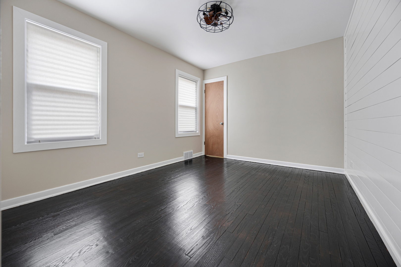 101 West 113th Place Chicago, IL 60628 - Photo 7 of 15 a view of an empty room with wooden floor and a window