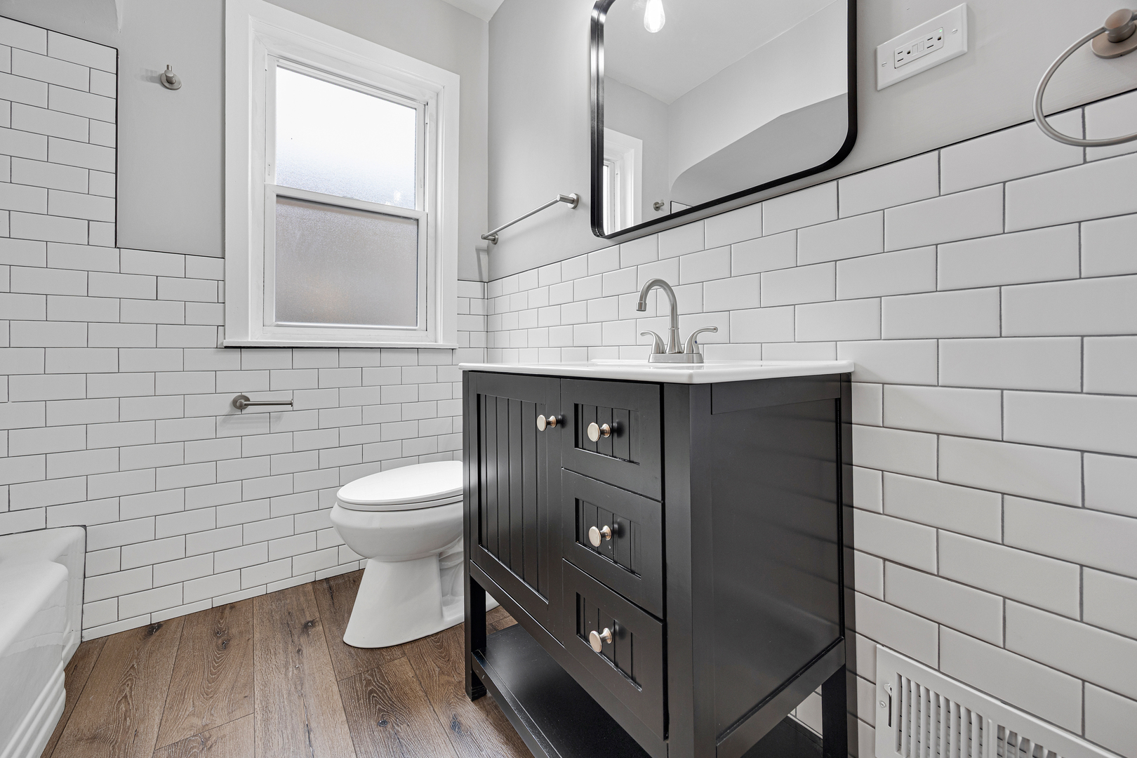 101 West 113th Place Chicago, IL 60628 - Photo 8 of 15 a bathroom with a toilet sink and mirror