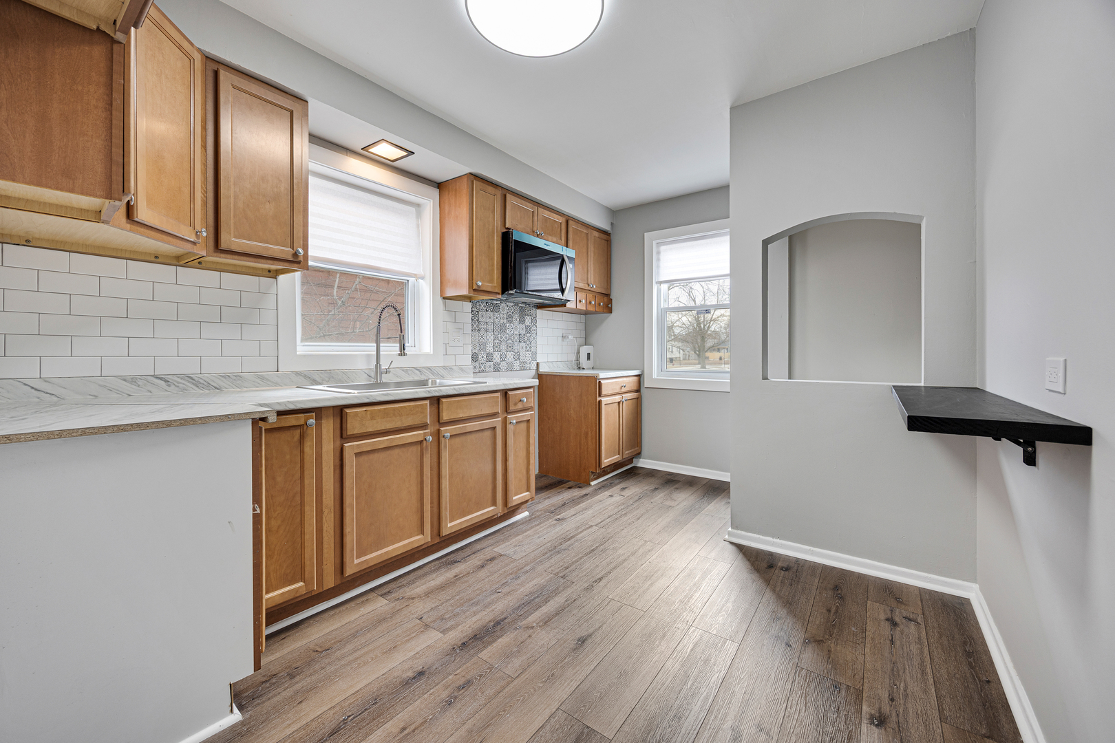 101 West 113th Place Chicago, IL 60628 - Photo 10 of 15 a kitchen with a sink cabinets and wooden floor