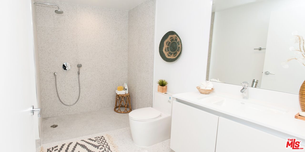 625 South Barrington Avenue, Unit 110 Los Angeles, CA 90049 - Photo 12 of 17 a bathroom with a sink mirror and toilet