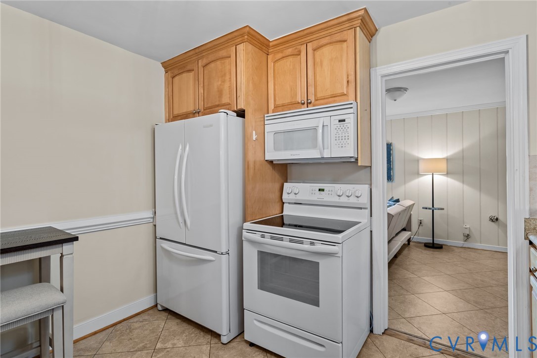 4804 Morrison Road Richmond, VA 23230 - Photo 16 of 48 a kitchen with stainless steel appliances white cabinets and a refrigerator