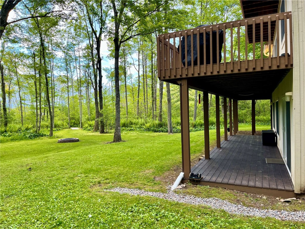 735 Howell Road Conquest, NY 13140 - Photo 18 of 49 Lower level Trex decking is protected by rain coll