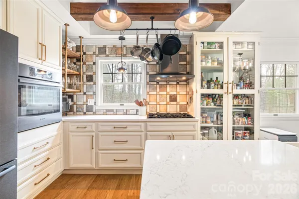 a dining room with furniture and a large window