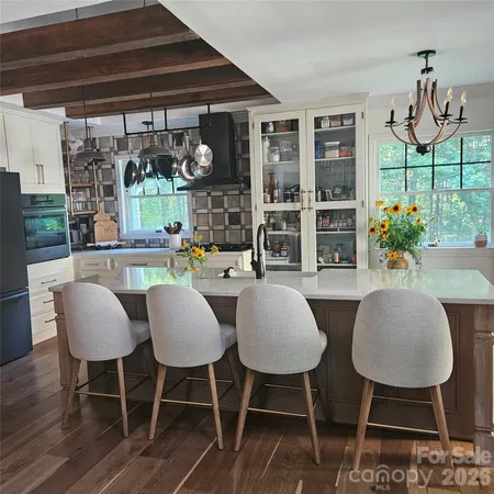 a kitchen that has a table and chairs in it