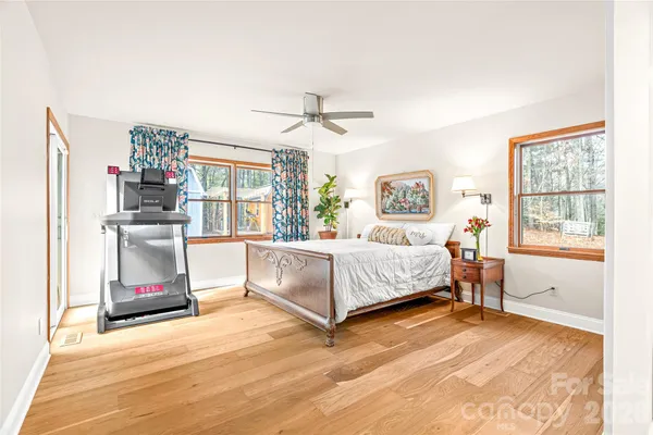 a living room with a large bed and a chandelier