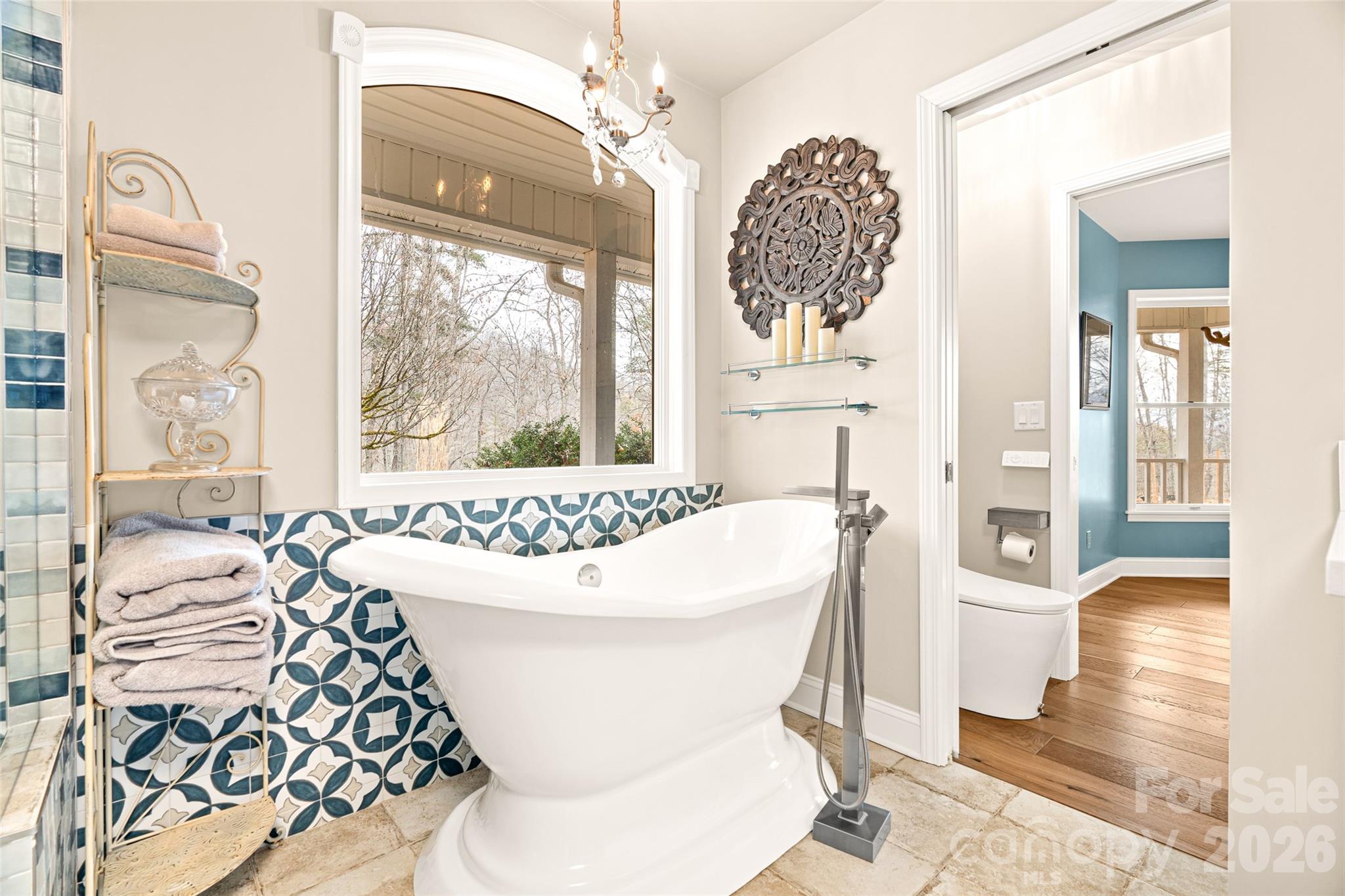 649 Upper Bailey Branch Road Mars Hill, NC 28754 - Photo 20 of 37 a living room with a large bed and a chandelier
