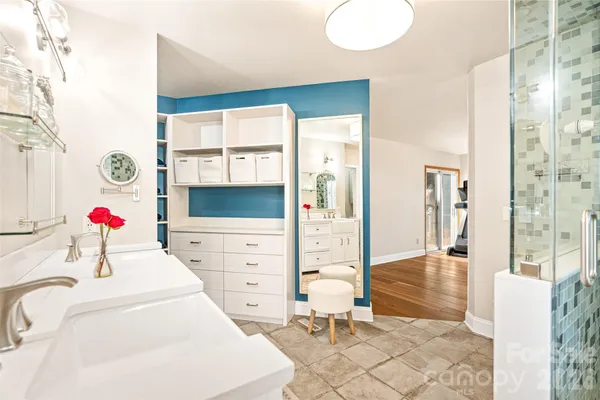 a spacious bathroom with a double vanity sink a mirror and a bathtub