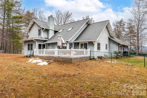 a front view of a house with a yard covered with snow