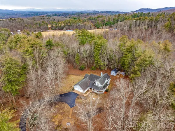 a bathroom with a granite countertop sink a mirror and a shower