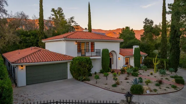 a front view of a house with garden