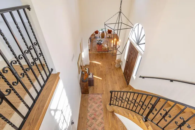 a view of a patio with couches chairs and wooden floor