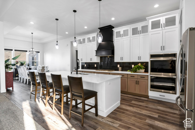 1952 Highway 118 Monroe, UT 84754 - Photo 40 of 88 Kitchen with appliances with stainless steel finishes, recessed lighting, tasteful backsplash, dark wood-type flooring, and custom range hood