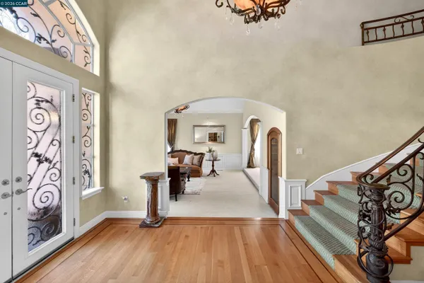 a view of a dining room with furniture wooden floor and chandelier