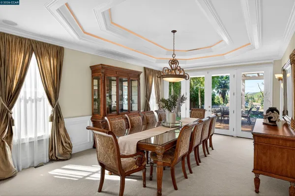 a living room with furniture a fireplace and a floor to ceiling window