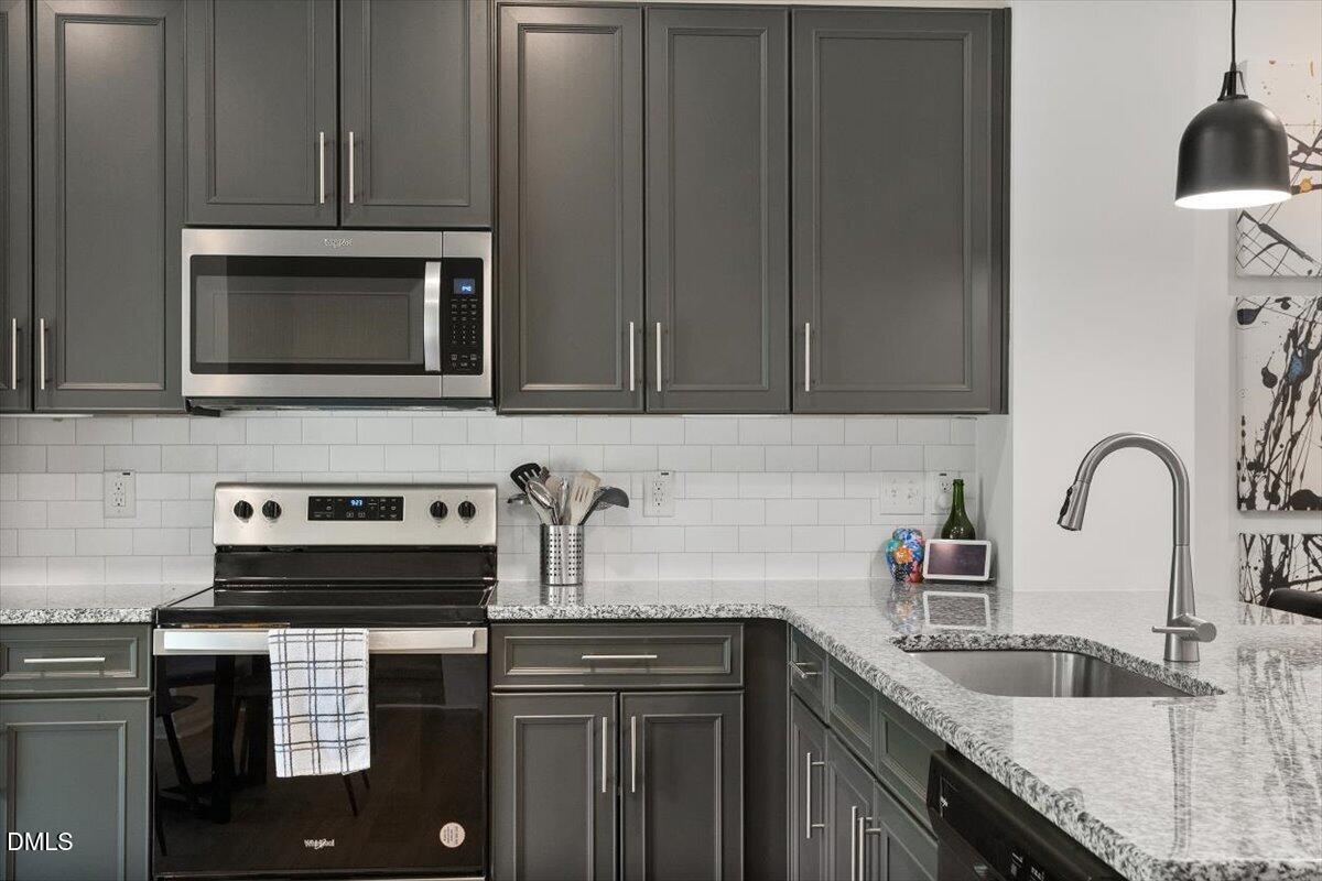 517 Hacksaw Trail Raleigh, NC 27610 - Photo 8 of 20 a kitchen with granite countertop a stove sink and cabinets