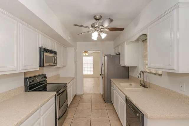 a kitchen with a sink stove and refrigerator