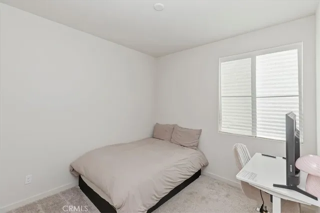 a bedroom with a bed and a table in it