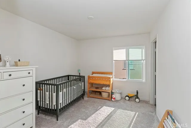 a room with a baby crib and a window