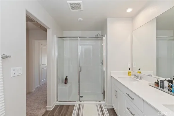 a bathroom with a sink a mirror and a shower