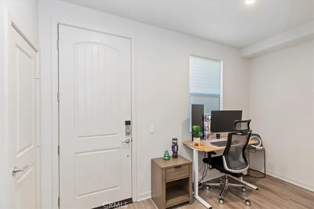 a view of a workspace with furniture and a window