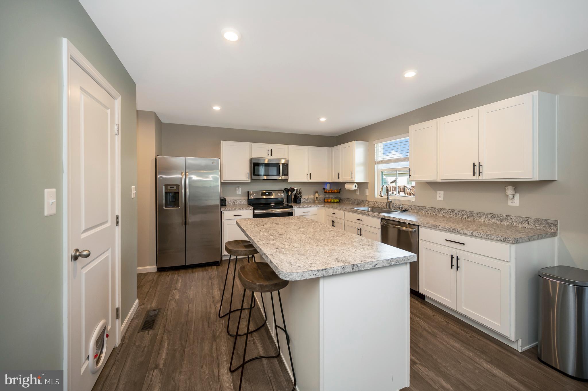 2188 Mallard Lane Locust Grove, VA 22508 - Photo 14 of 45 a kitchen with stainless steel appliances granite countertop a refrigerator a sink a stove a microwave and island