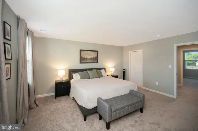 a bedroom with a bed rug and a bathroom