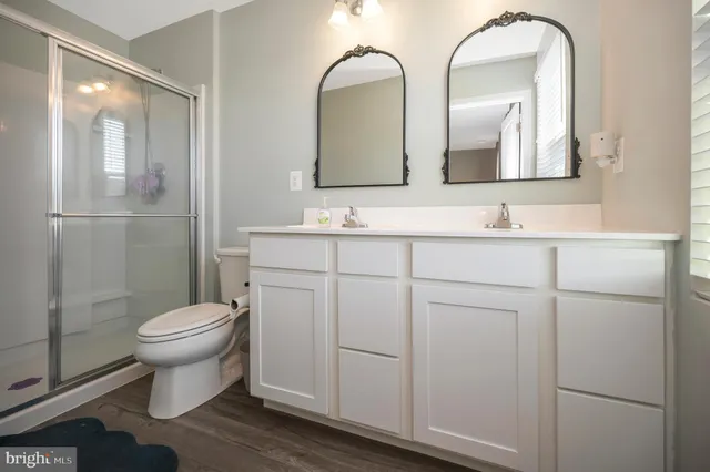 a bathroom with a toilet sink and mirror