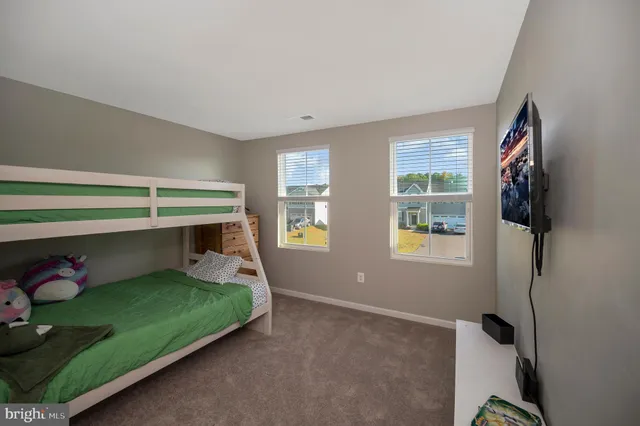 a bedroom with a bed and windows