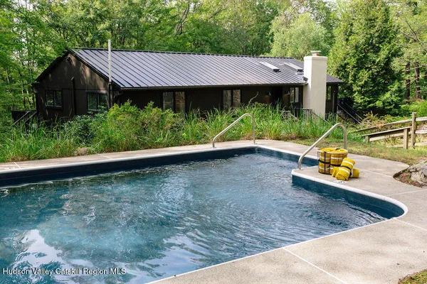 a view of a small house with wooden fence