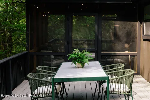 a table and chairs with potted plants on wooden roof