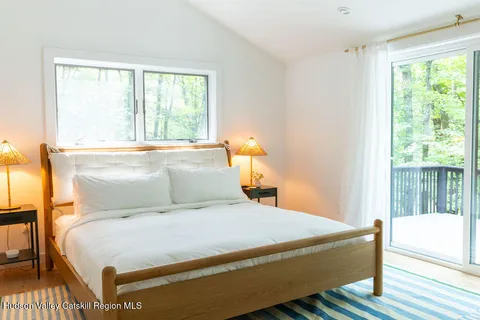 a bedroom with a large bed and a window