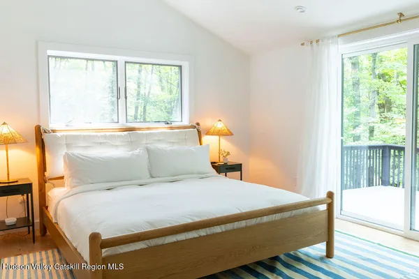 a bedroom with a large bed and a window