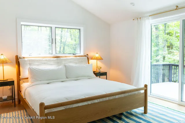 a bedroom with a large bed and a window