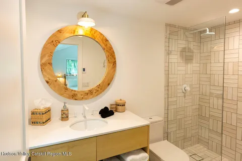 a bathroom with a sink mirror vanity and toilet
