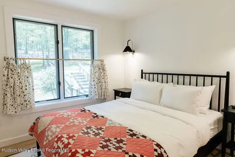 a bedroom with a large bed and a large window