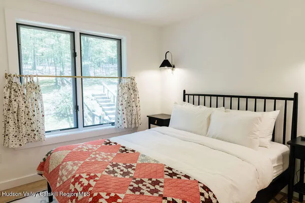 a bedroom with a large bed and a large window