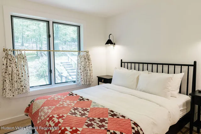 a bedroom with a large bed and a large window