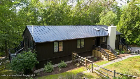 a view of a patio with table and chairs with wooden fence and plants