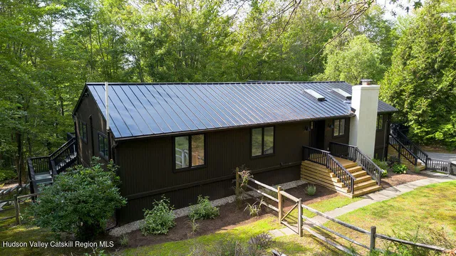 a view of a patio with table and chairs with wooden fence and plants