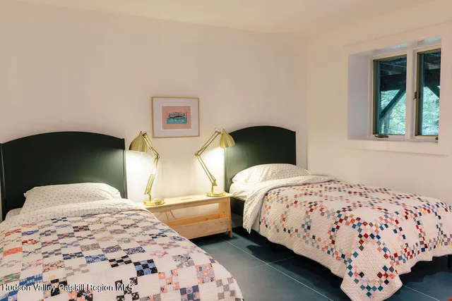 a bedroom with a bed and window